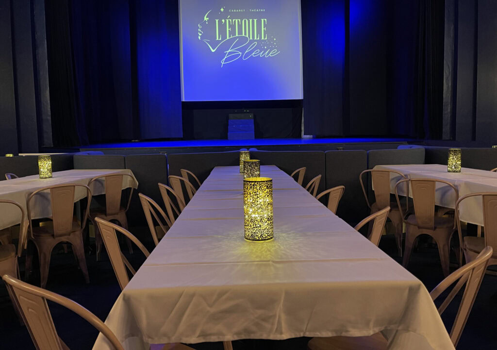 Balcony with tables and candles in the cabaret L'étoile bleue in Marseille.