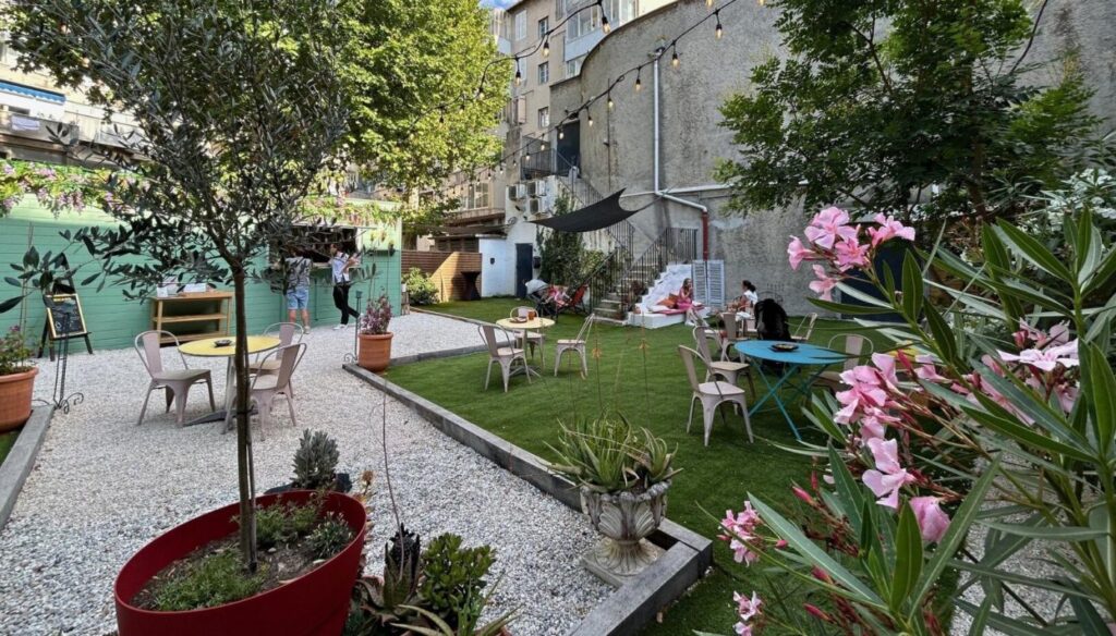Outdoor cabaret space in Marseille with furniture and plants.