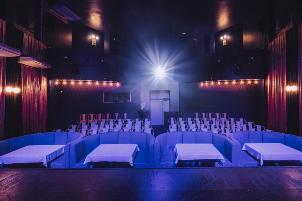 Blue Star, theatre and music venue in Marseille, cabaret atmosphere with seating and illuminated stage.